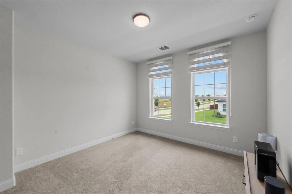 10969 Coastal Violet Road Frisco, TX 75035 - Photo 12 of 30 Empty room featuring carpet and baseboards