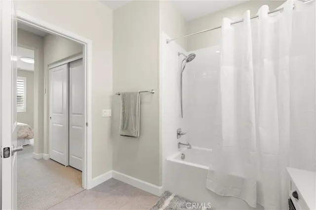 a bathroom with a shower curtain and a tub