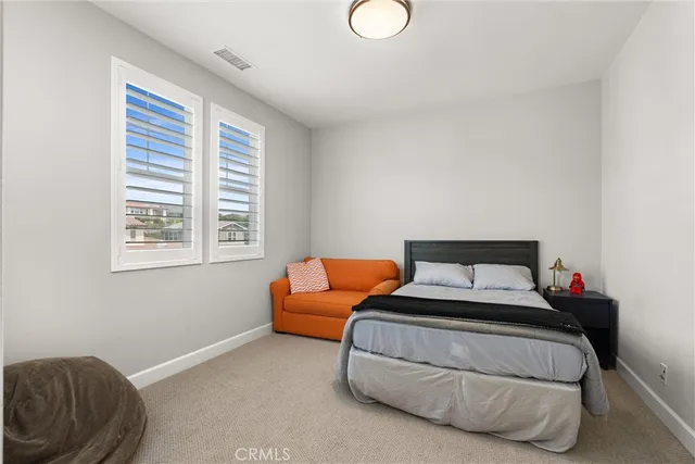 a bedroom with bed and window