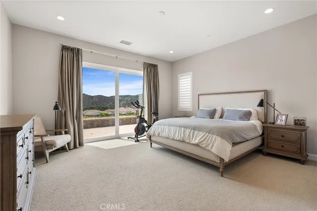 a bedroom with a bed and large window