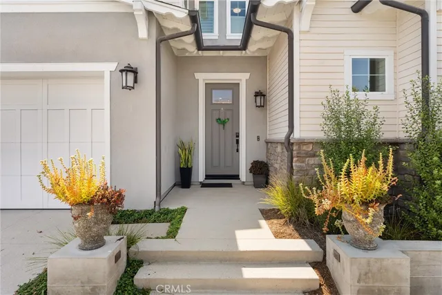 a view of a house with potted plants