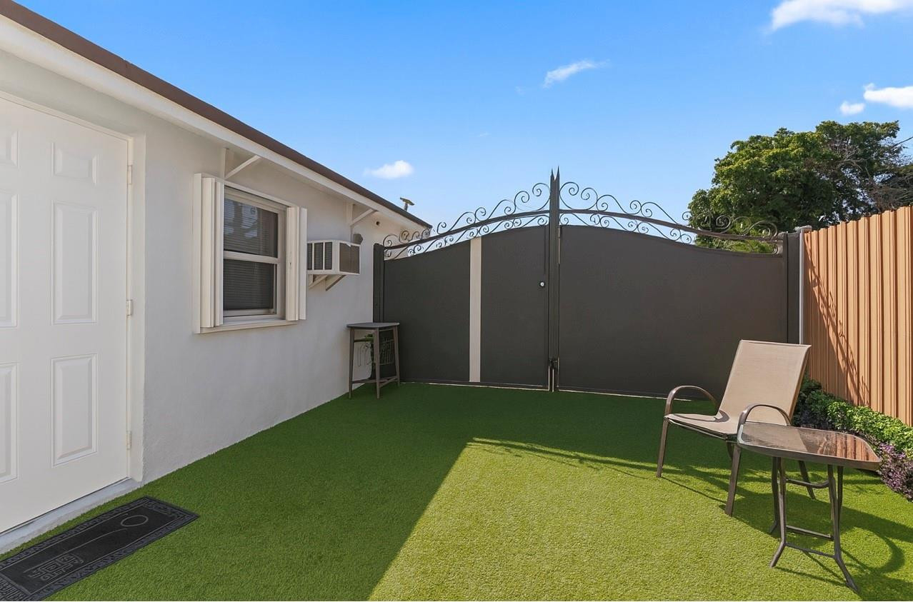 31 Miami Gardens Road West Park, FL 33023 - Photo 20 of 36 a backyard of a house with table and chairs
