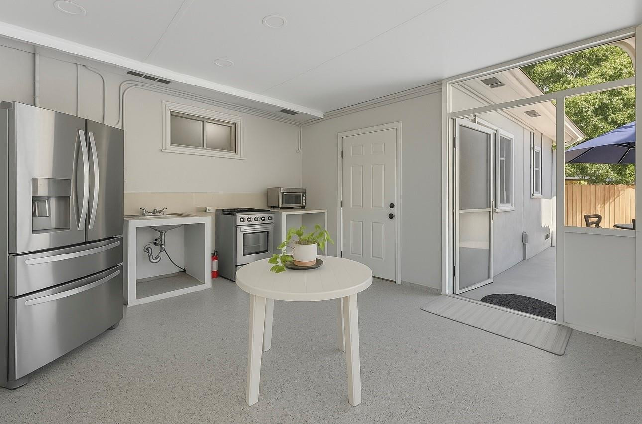 31 Miami Gardens Road West Park, FL 33023 - Photo 21 of 36 a kitchen with stainless steel appliances granite countertop a refrigerator a sink a stove and white cabinets