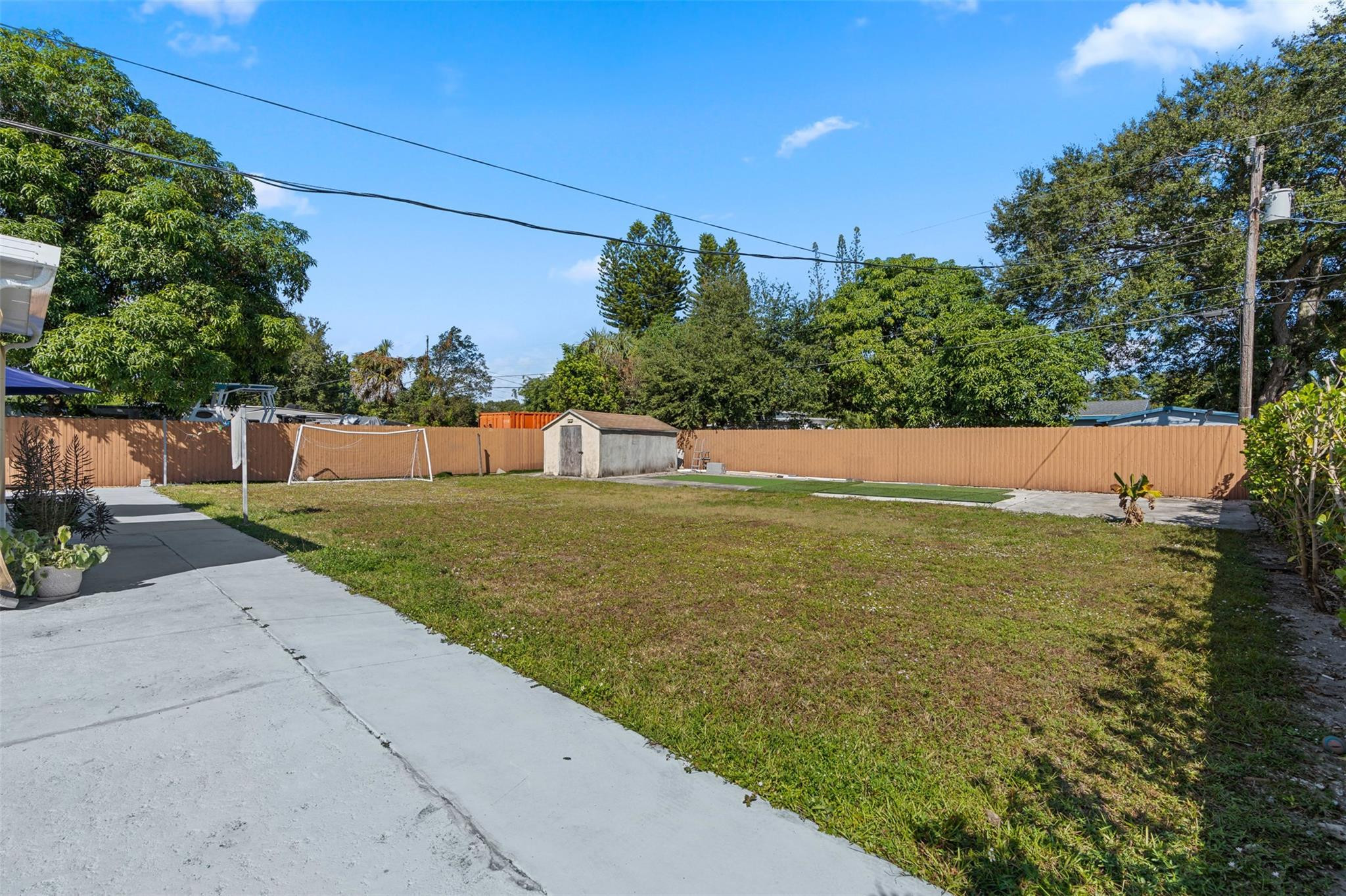 31 Miami Gardens Road West Park, FL 33023 - Photo 25 of 36 a view of yard with swimming pool and trees in the background
