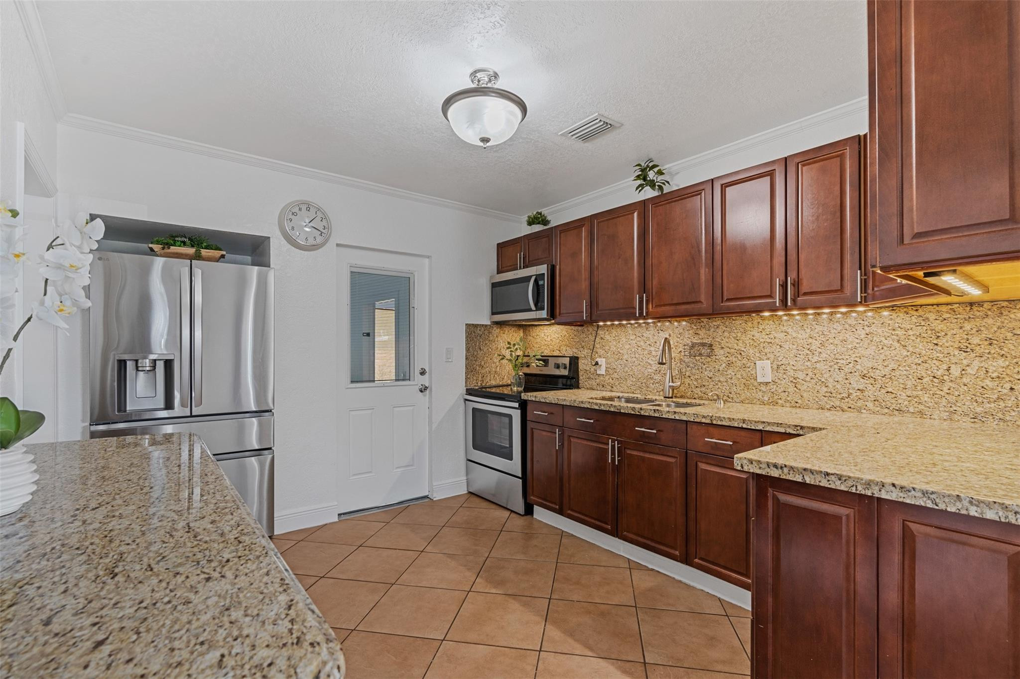 31 Miami Gardens Road West Park, FL 33023 - Photo 6 of 36 a kitchen with stainless steel appliances granite countertop a stove sink and cabinets