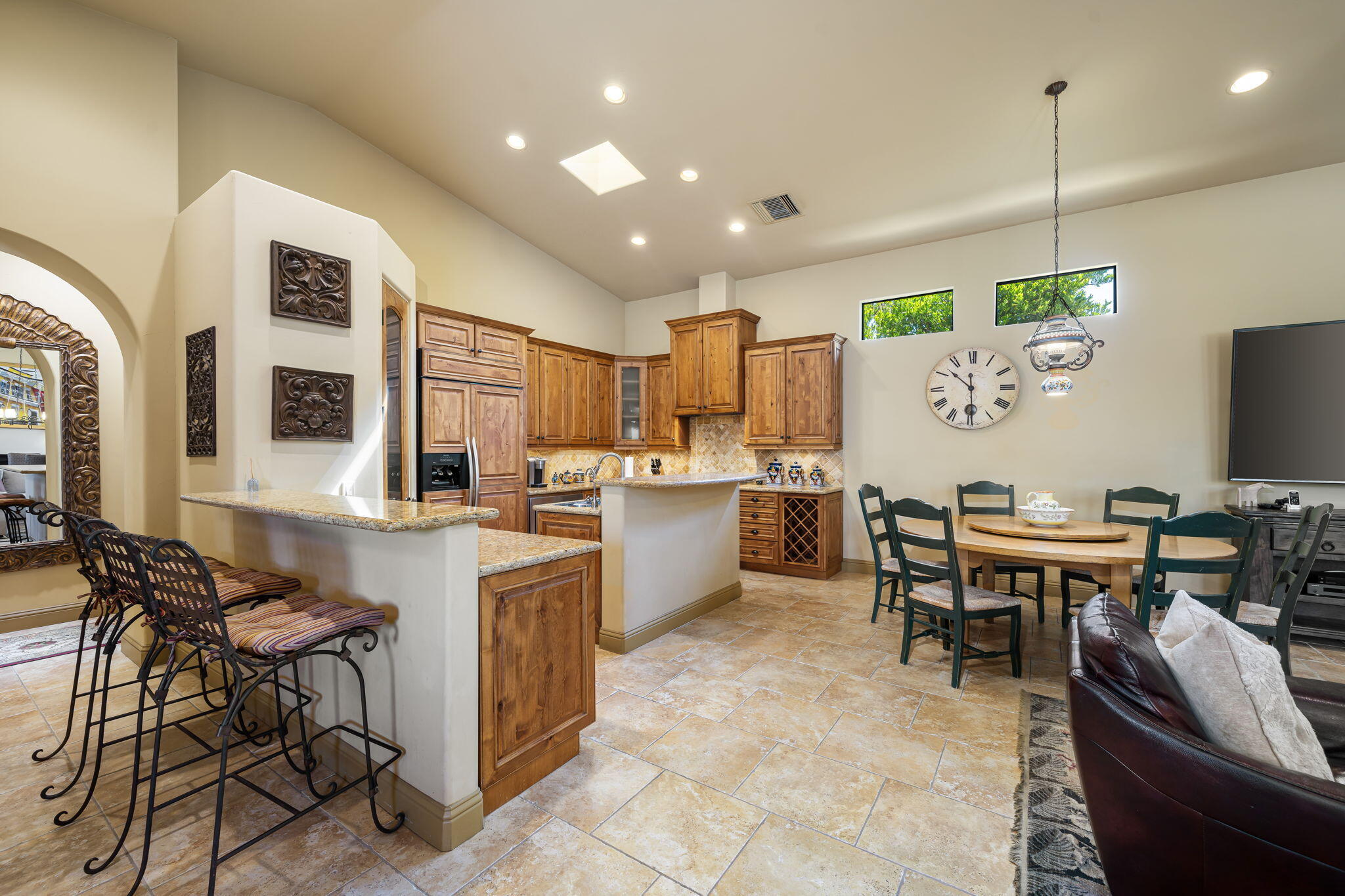 42590 Sandy Bay Road Bermuda Dunes, CA 92203 - Photo 12 of 45 a kitchen with stainless steel appliances kitchen island granite countertop a table and chairs in it