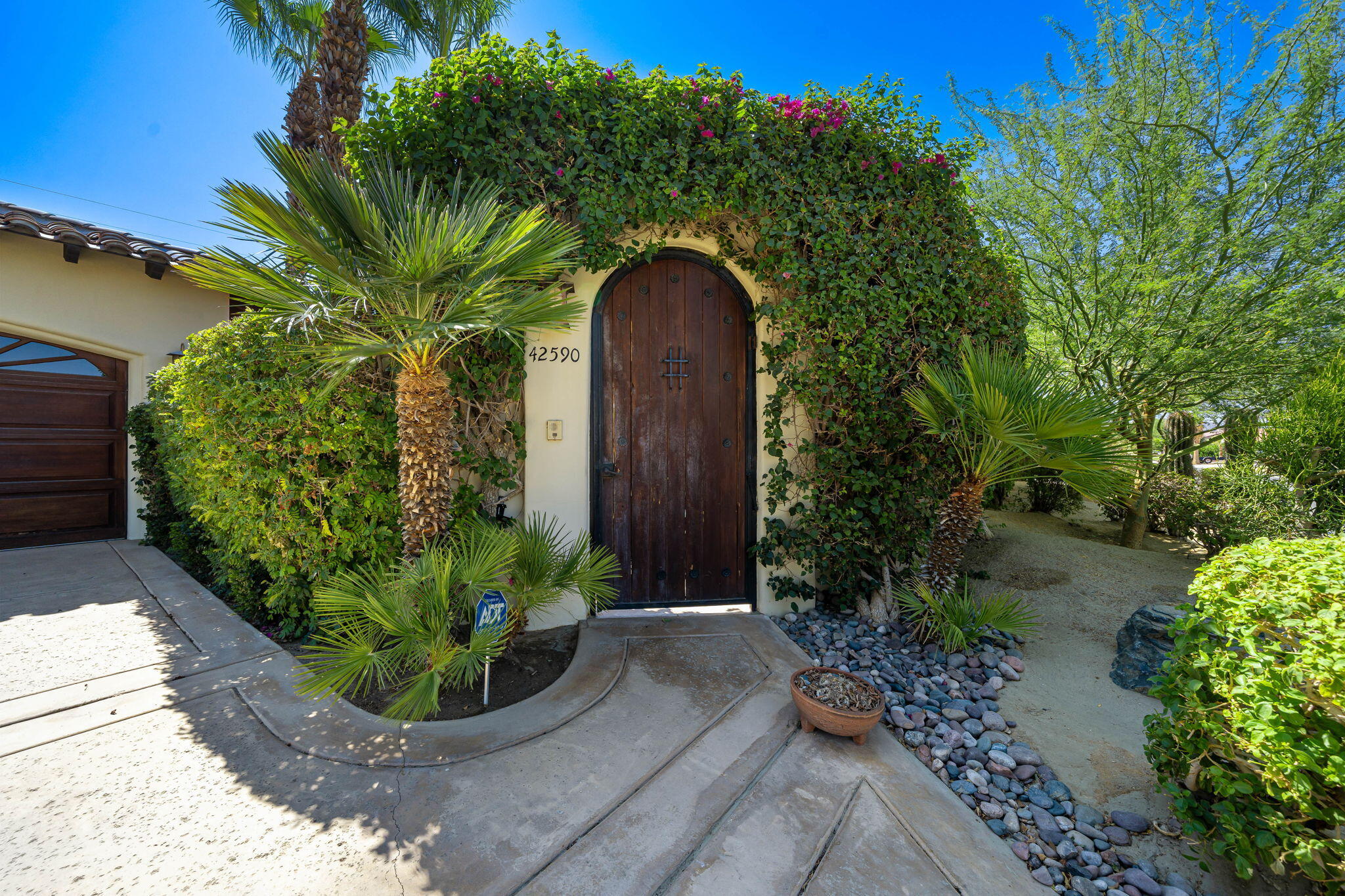 42590 Sandy Bay Road Bermuda Dunes, CA 92203 - Photo 42 of 45 a front view of a house with garden