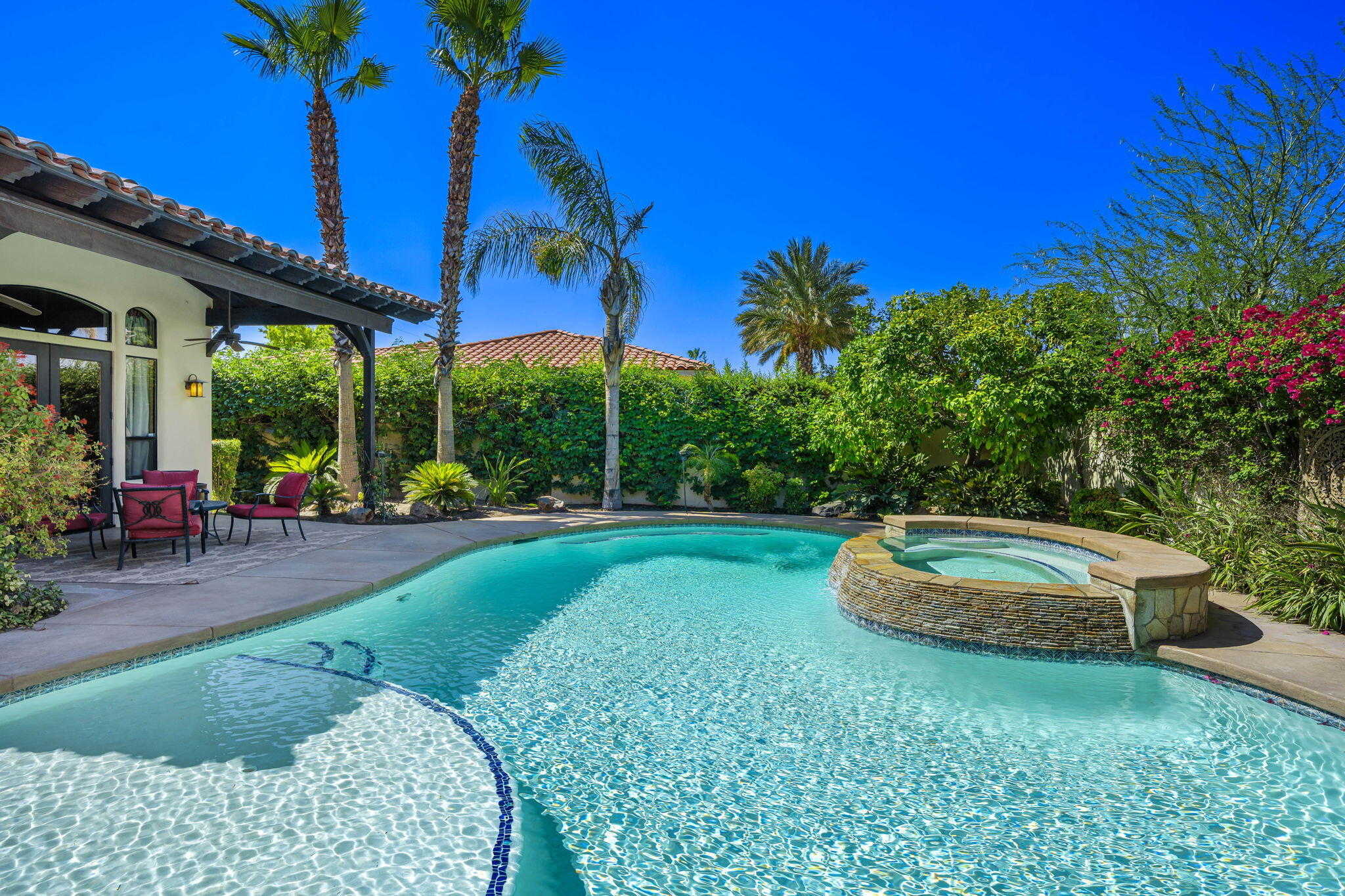 42590 Sandy Bay Road Bermuda Dunes, CA 92203 - Photo 5 of 45 a view of a house with a backyard and a patio