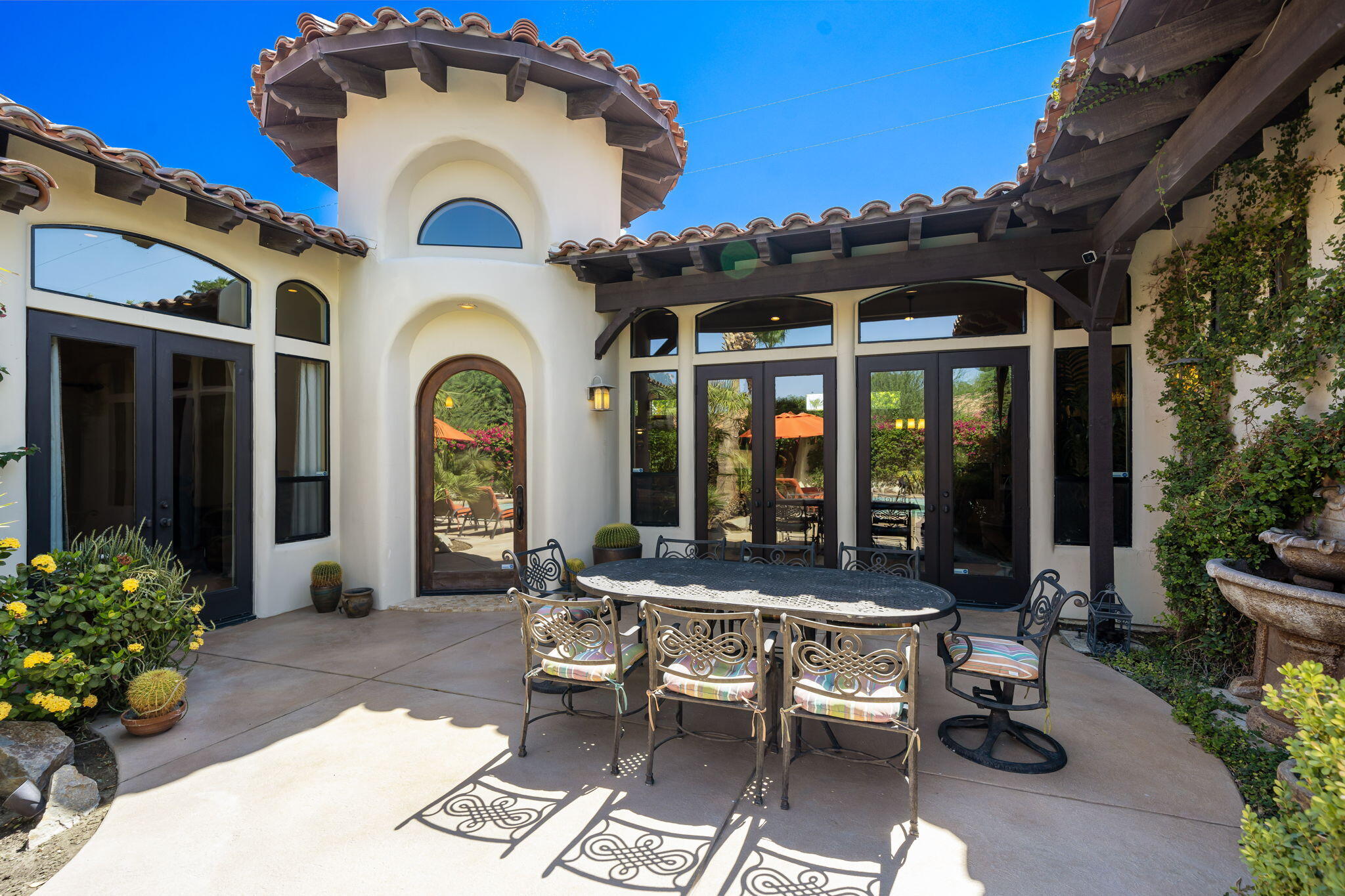 42590 Sandy Bay Road Bermuda Dunes, CA 92203 - Photo 9 of 45 a view of a patio with table and chairs and potted plants