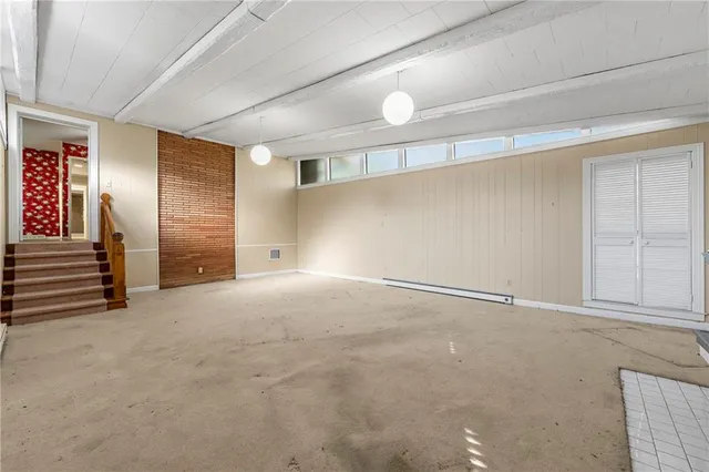 a kitchen that has a lot of cabinets and window