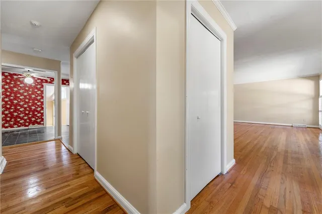 a view of hallway with wooden floor