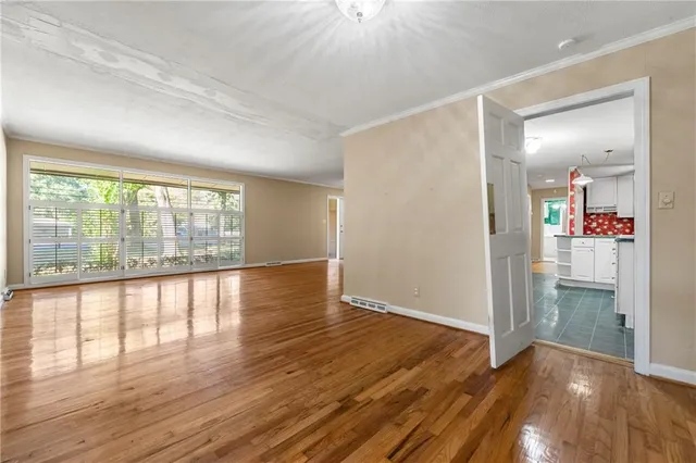 wooden floor in an empty room with a window