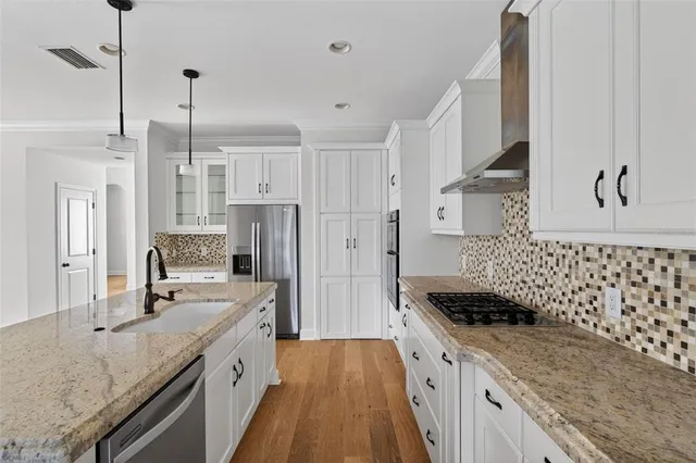 a kitchen with sink stove and cabinets