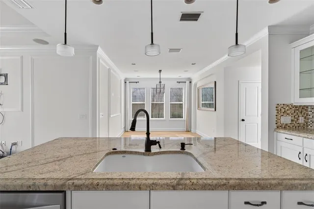 a view of empty room with wooden floor and windows