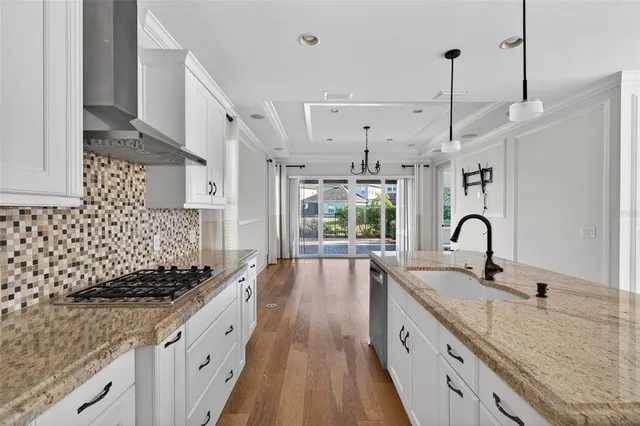 a view of a room with wooden floor and white walls