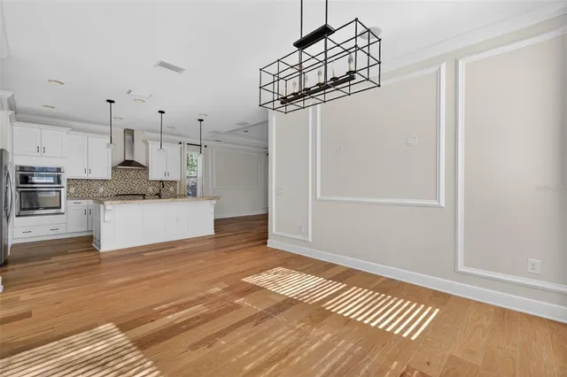 a view of an empty room with a window and a flat screen tv