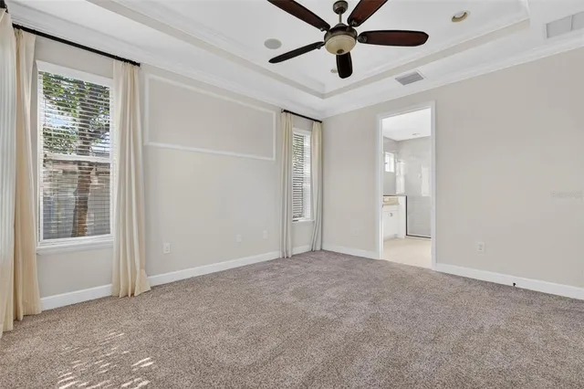 an empty room with a window and a fan