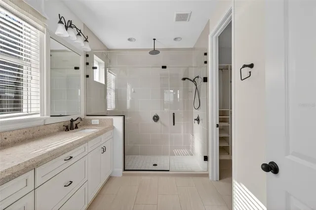 a view of a house with a yard and potted plants