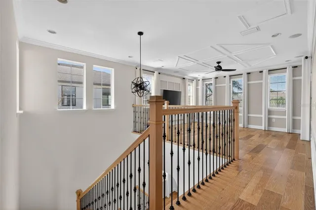 front view of a house with a large window and potted plants