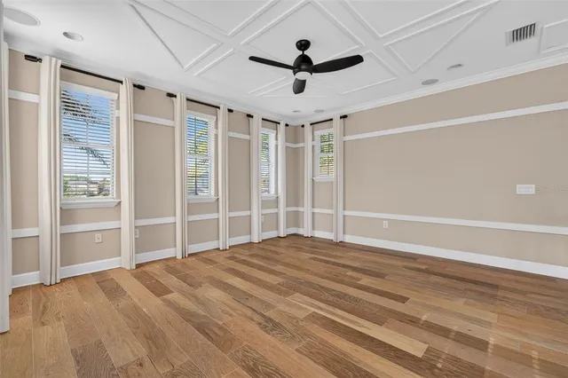 an aerial view of residential houses with outdoor space and ocean view