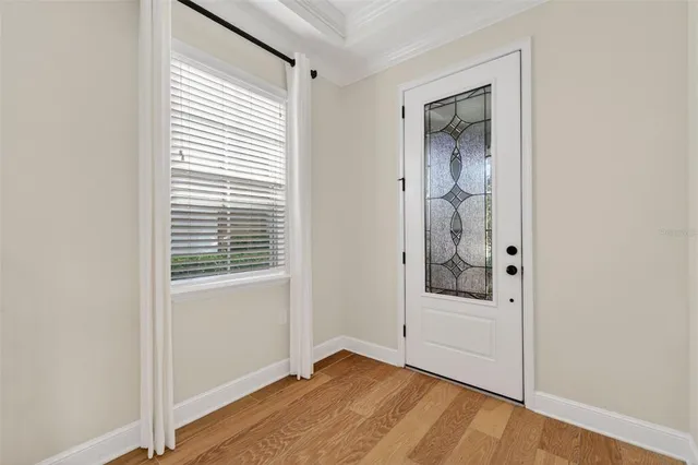 a view of a room with wooden floor and windows