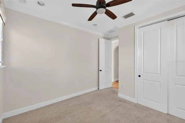 a living room filled with furniture and floor to ceiling window