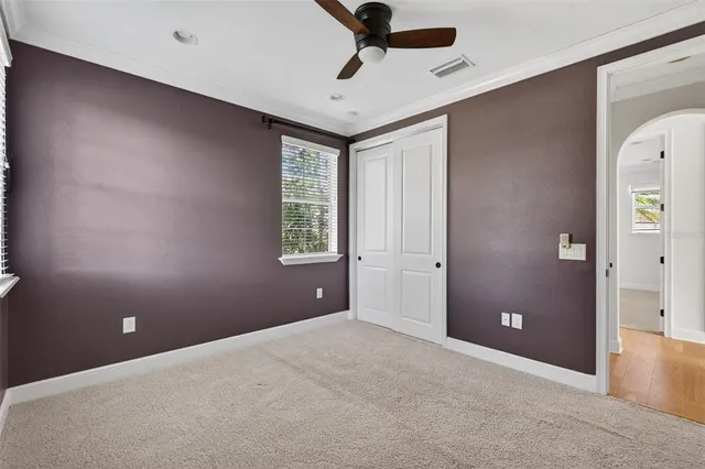 an aerial view of a house with a yard and large trees