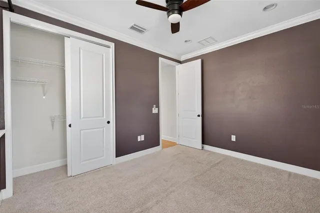 an aerial view of residential house with outdoor space and trees all around