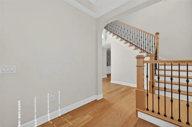 a view of entryway with wooden floor and stairs
