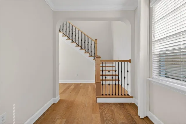 a kitchen with kitchen island granite countertop a sink stove and wooden floor