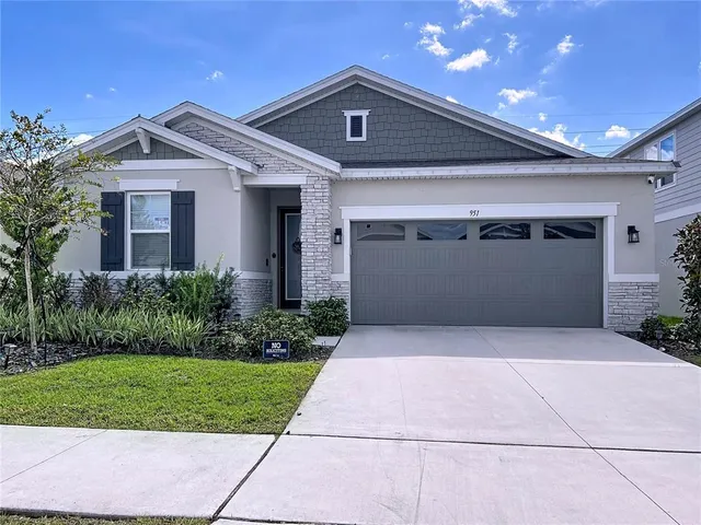 a front view of a house with a yard and a garage