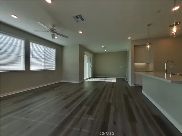a view of a room with wooden floor and window