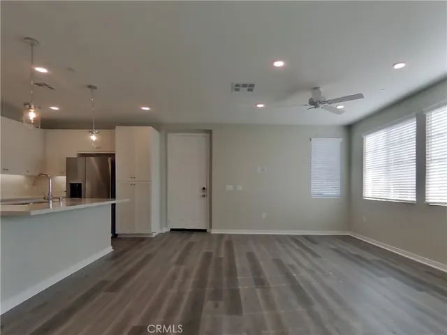 a view of wooden floor and windows in a room
