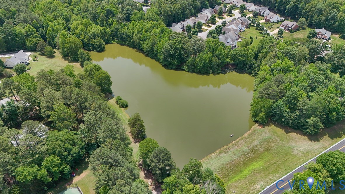 604 Cross Ridge Lane Manakin-Sabot, VA 23103 - Photo 46 of 50 Expansive pond surrounded by mature trees, with re
