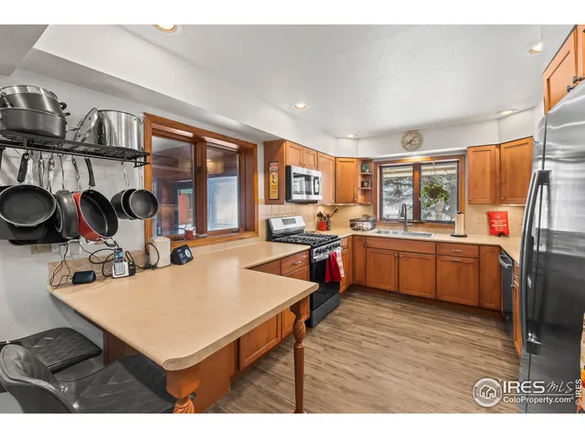 a living room with furniture a flat screen tv and a window