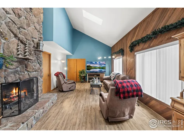 a spacious bedroom with a bed a dresser and next to a window