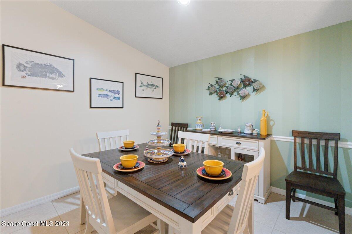 7667 North Wickham Road, Unit 916 Melbourne, FL 32940 - Photo 11 of 53 a view of a dining room with furniture and rug