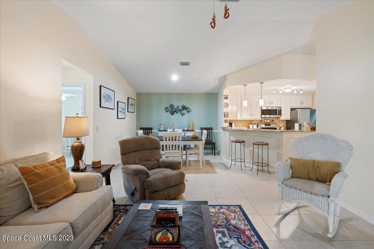 7667 North Wickham Road, Unit 916 Melbourne, FL 32940 - Photo 14 of 53 a living room with furniture and a table