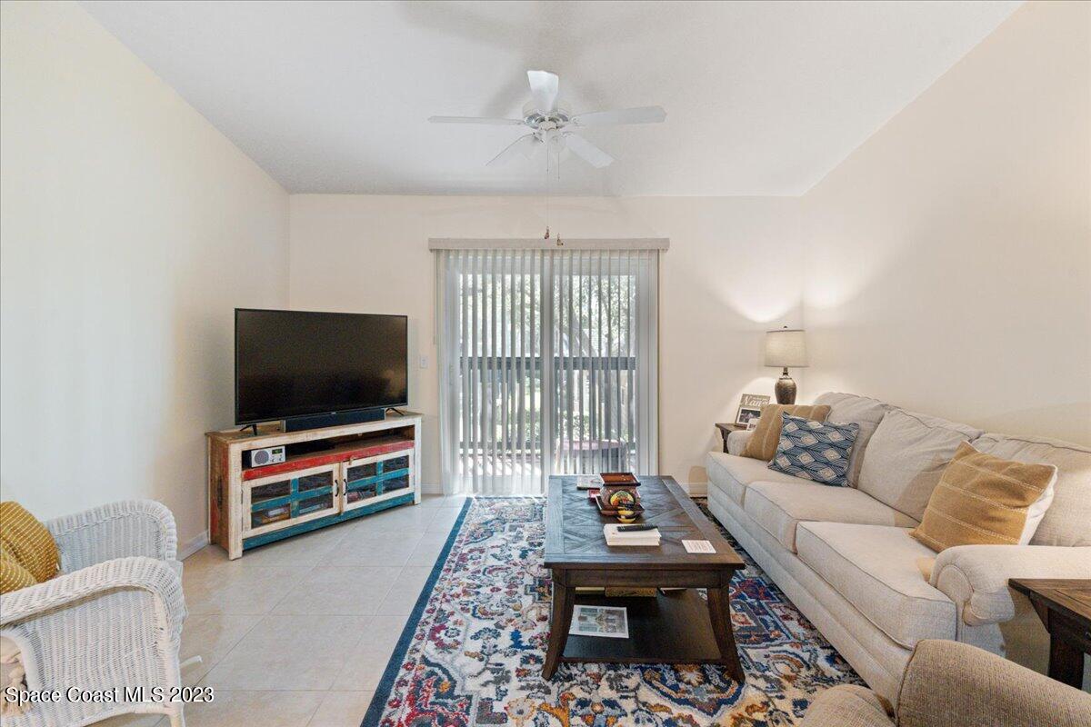 7667 North Wickham Road, Unit 916 Melbourne, FL 32940 - Photo 15 of 53 a living room with furniture and a flat screen tv