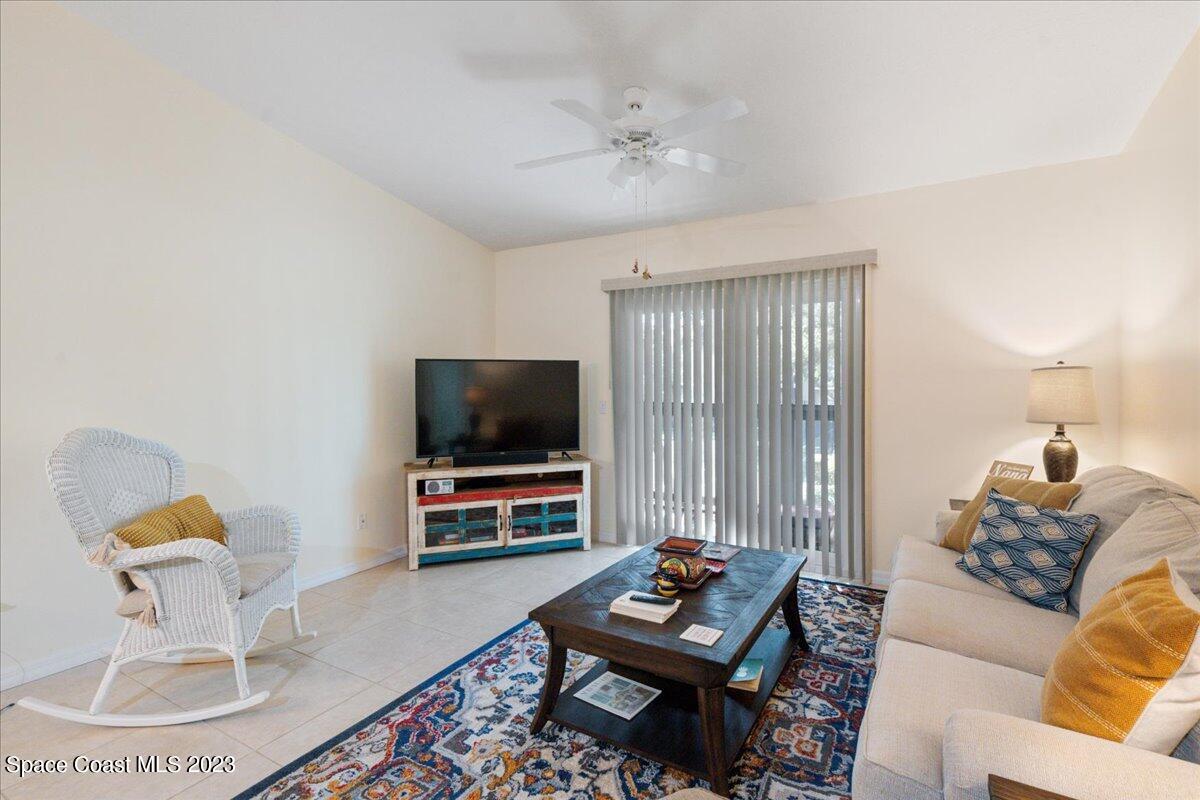 7667 North Wickham Road, Unit 916 Melbourne, FL 32940 - Photo 16 of 53 a living room with furniture and a flat screen tv