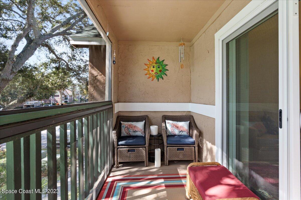 7667 North Wickham Road, Unit 916 Melbourne, FL 32940 - Photo 17 of 53 a balcony view with couple of chairs