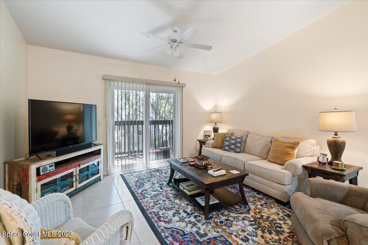 7667 North Wickham Road, Unit 916 Melbourne, FL 32940 - Photo 18 of 53 a living room with furniture and a flat screen tv