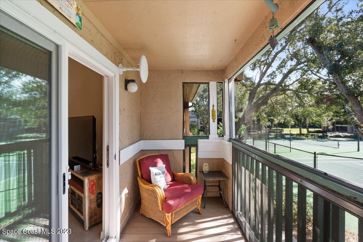 7667 North Wickham Road, Unit 916 Melbourne, FL 32940 - Photo 20 of 53 a view of a porch with furniture and a yard