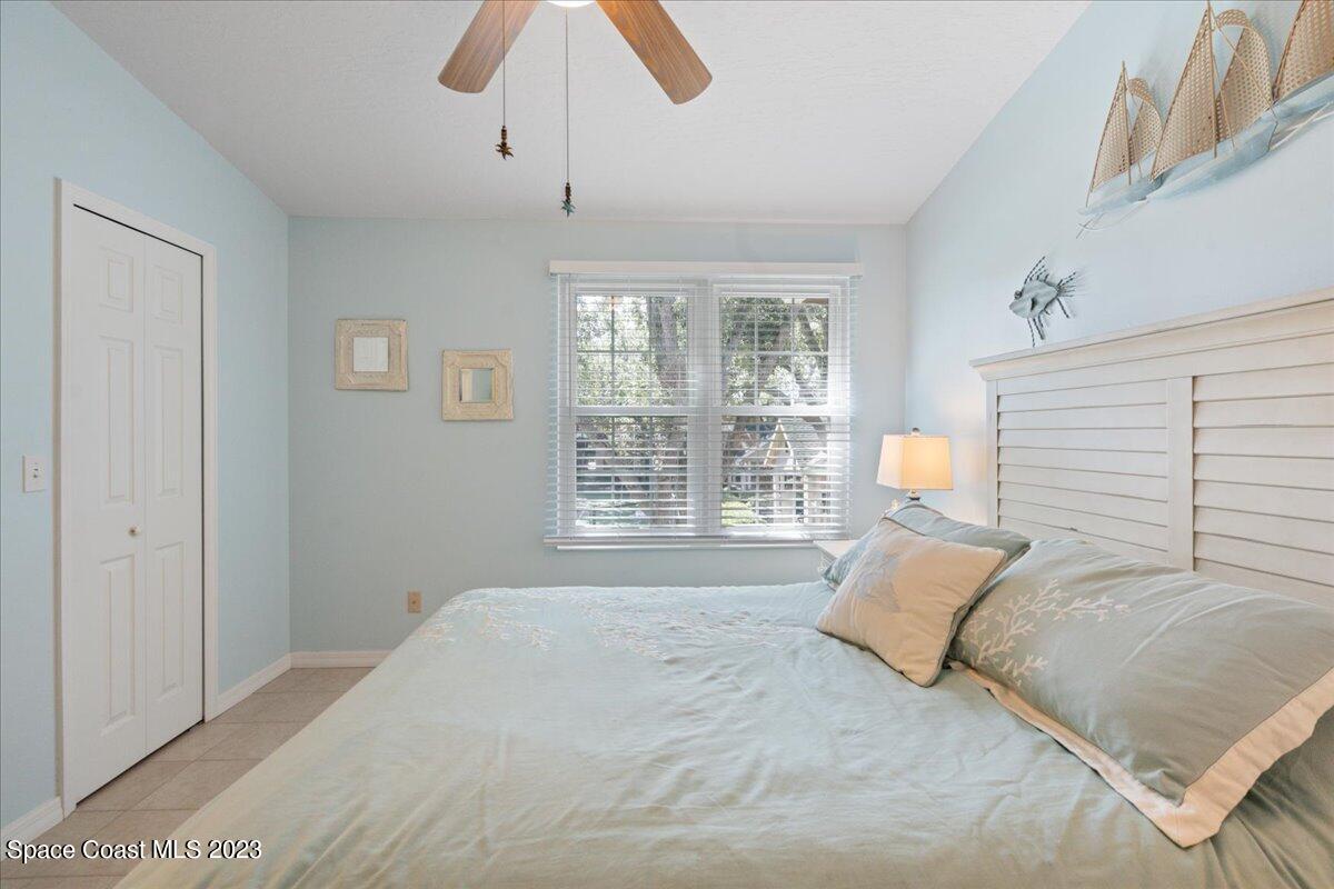 7667 North Wickham Road, Unit 916 Melbourne, FL 32940 - Photo 23 of 53 a spacious bedroom with a bed and a window