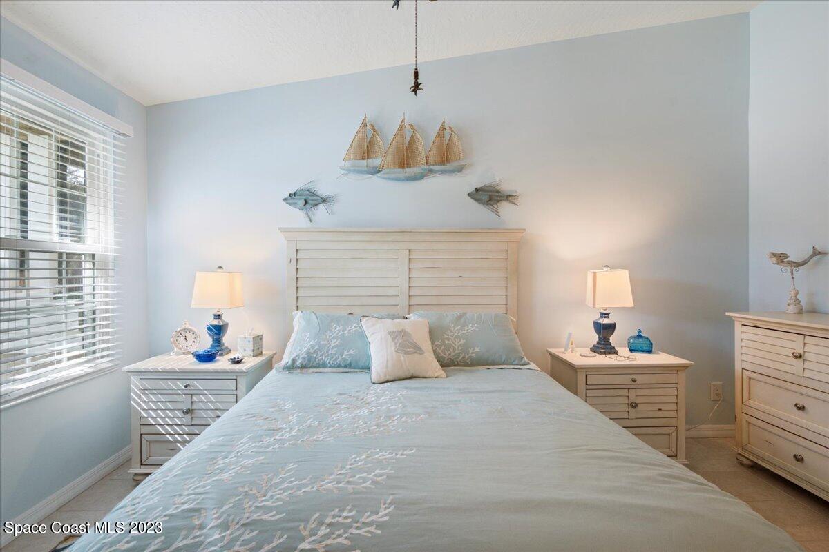 7667 North Wickham Road, Unit 916 Melbourne, FL 32940 - Photo 27 of 53 a bedroom with a bed and window