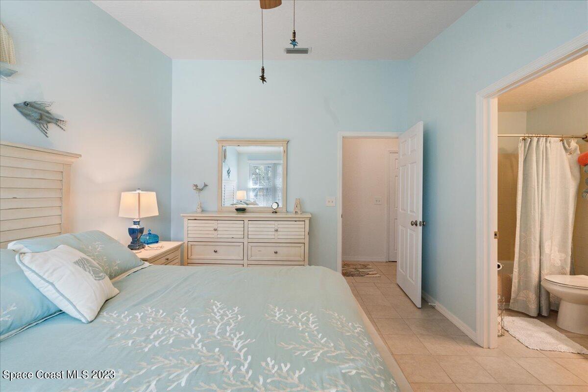 7667 North Wickham Road, Unit 916 Melbourne, FL 32940 - Photo 28 of 53 a bedroom with a large bed and a window