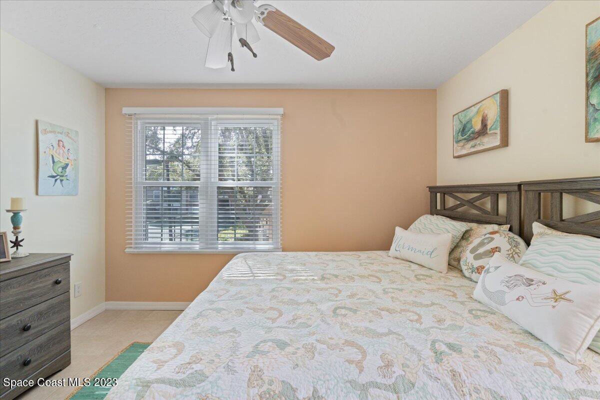 7667 North Wickham Road, Unit 916 Melbourne, FL 32940 - Photo 32 of 53 a bedroom with a large bed and a window