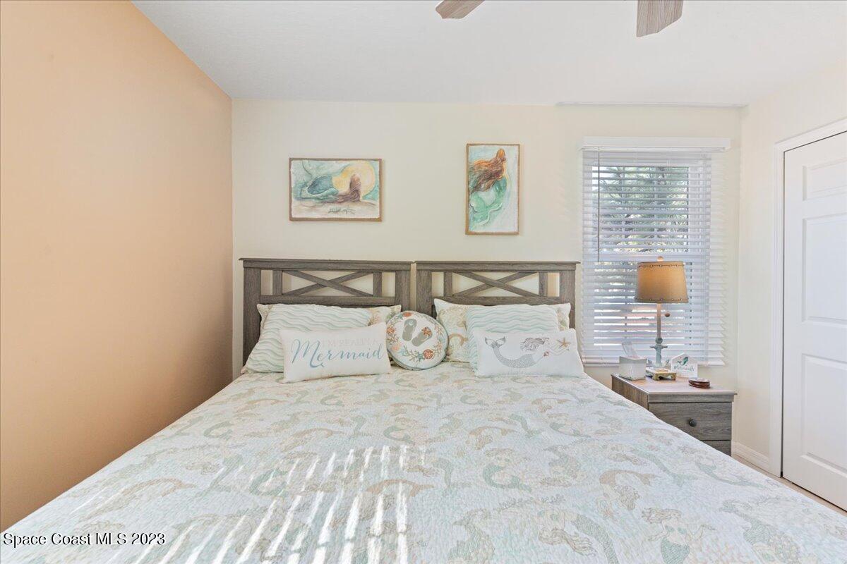 7667 North Wickham Road, Unit 916 Melbourne, FL 32940 - Photo 33 of 53 a bedroom with a large bed and a window