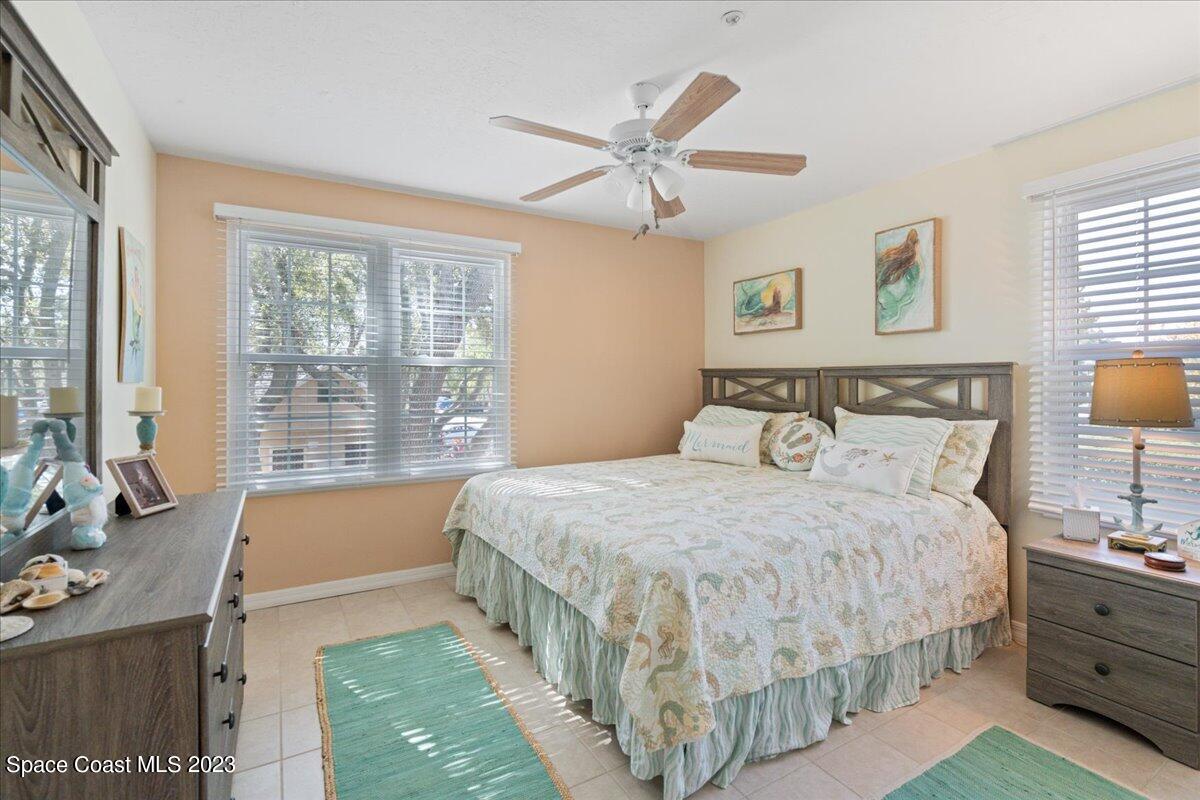 7667 North Wickham Road, Unit 916 Melbourne, FL 32940 - Photo 34 of 53 a bedroom with a bed and a night stand