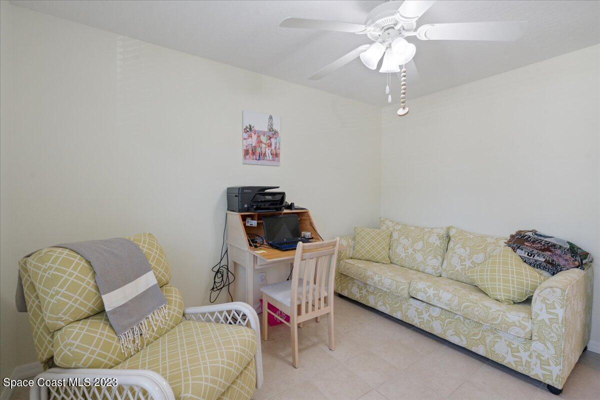 7667 North Wickham Road, Unit 916 Melbourne, FL 32940 - Photo 39 of 53 a living room with furniture and a chandelier